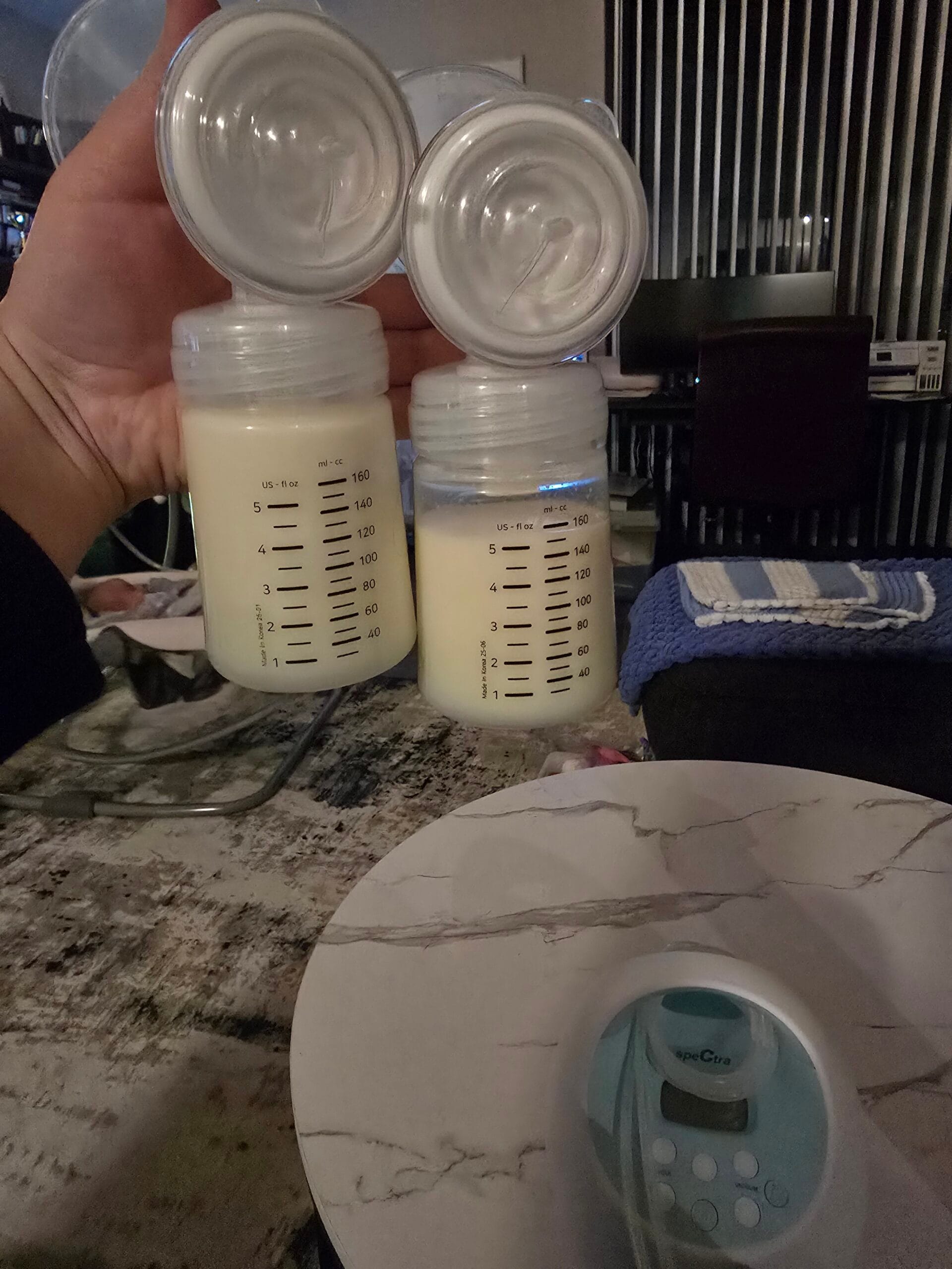 Power Pumping Schedule That Increased My Supply 3 Two Spectra breast pump bottles filled with pumped breast milk after a power pumping session
